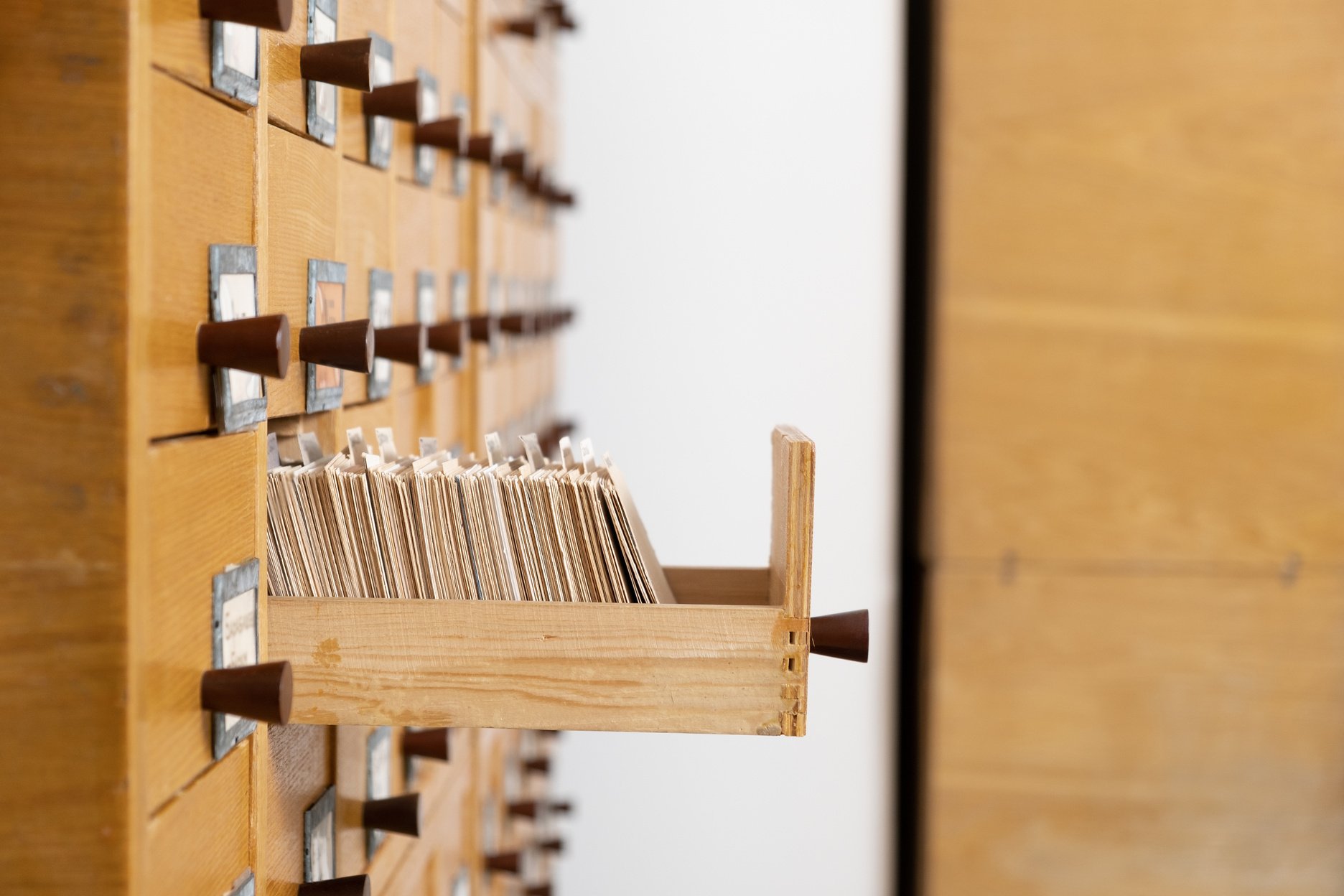 Old library reference catalogue with opened card drawer. Library or archive reference card catalog"n